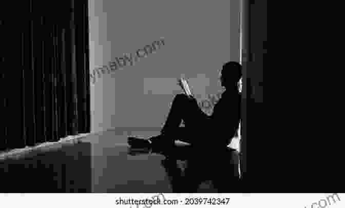 A Man Sitting Alone In A Dark Room, Head In Hands, Struggling With Addiction Relapse Jake Anderson