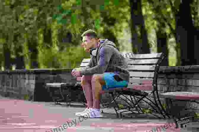 A Young Black Man Sits On A Bench In A Park, Looking Thoughtful. Makes Me Wanna Holler: A Young Black Man In America